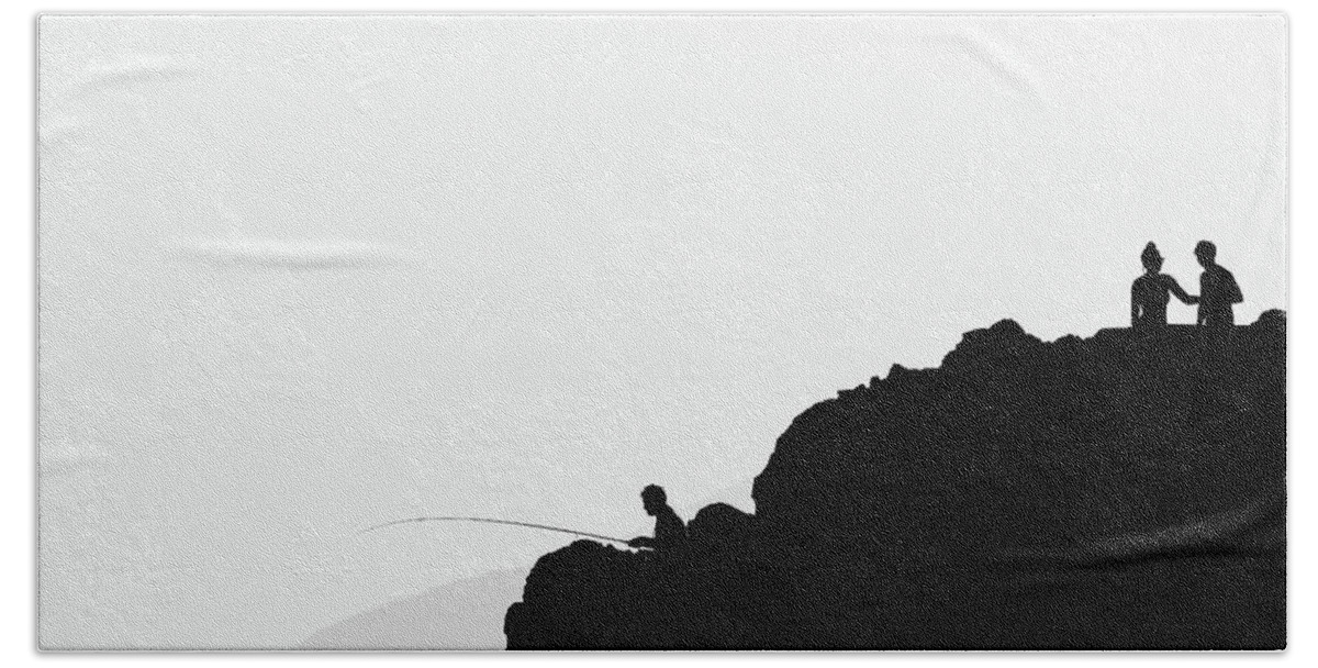 Minimalist Hand Towel featuring the photograph Minimalist photography of silhouettes on the rock above the sea by Martin Vorel Minimalist Photography