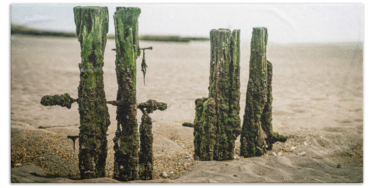 New England Hand Towel featuring the photograph Old pilings in a tidal flat by Kyle Lee
