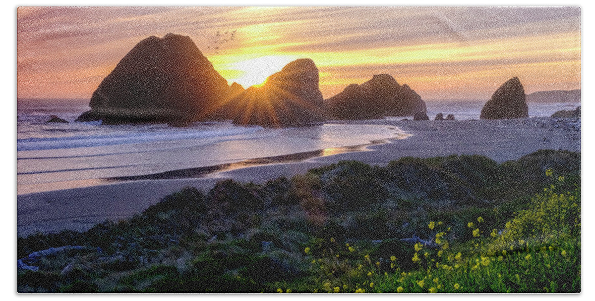 Sunset Bath Towel featuring the photograph Oregon Coastline Sunset Behind A Large Rock Formations by Tony Locke