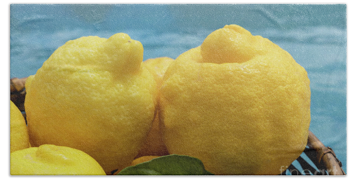 Fruit Bath Towel featuring the photograph Sunny yellow lemons and blue water by Adriana Mueller