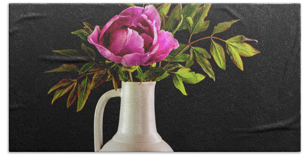 Tree Peony Bath Towel featuring the photograph Tree peony Lan He Paeonia suffruticosa rockii in a white vase on a black background by Torbjorn Swenelius