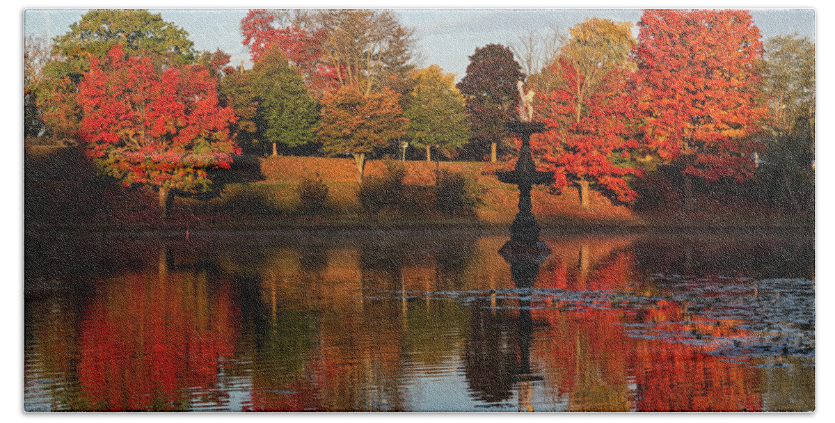 Newburyport Bath Towel featuring the photograph Vibrant Fall Colors on the Newburyport Frog Pond Newburyport Massachusetts Fountain by Toby McGuire