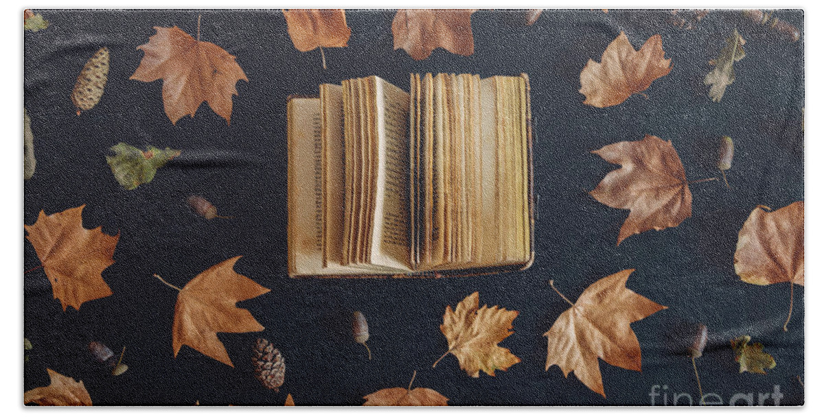 Autumn Bath Towel featuring the photograph Vintage book and autumn maple leaves on dark background from abo by Jelena Jovanovic