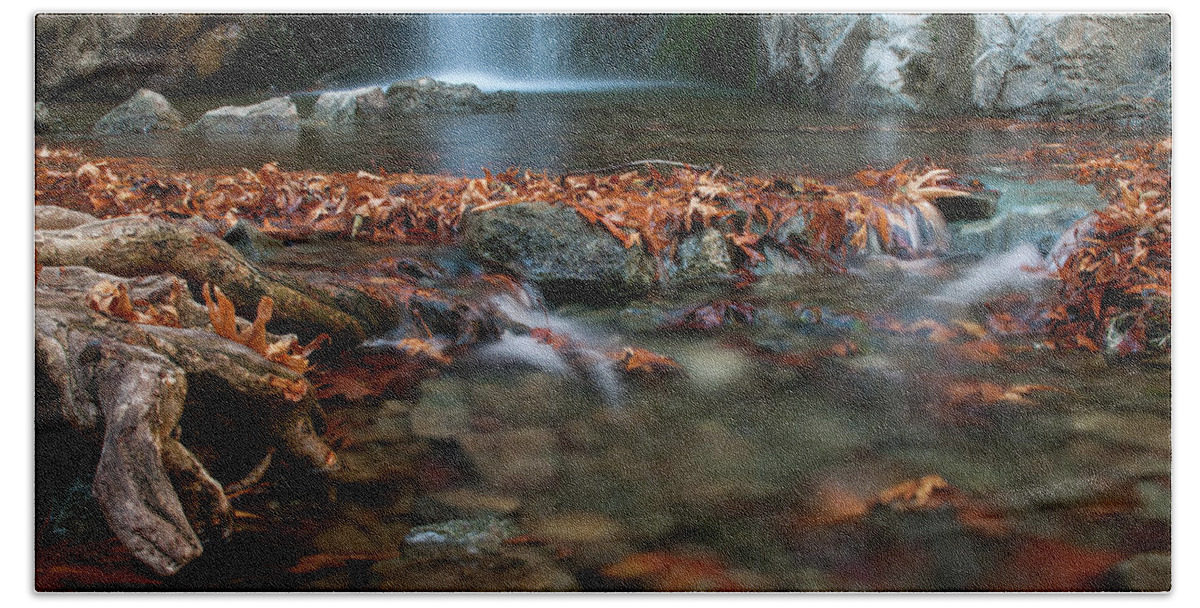 Troodos Bath Towel featuring the photograph Waterfall and river flowing with maple leaves on the rocks on the river in Autumn by Michalakis Ppalis