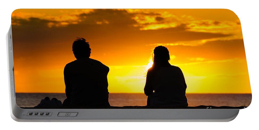 Hawaii Portable Battery Charger featuring the photograph Couple watching the sunset on a beach in Maui Hawaii USA #1 by Don Landwehrle