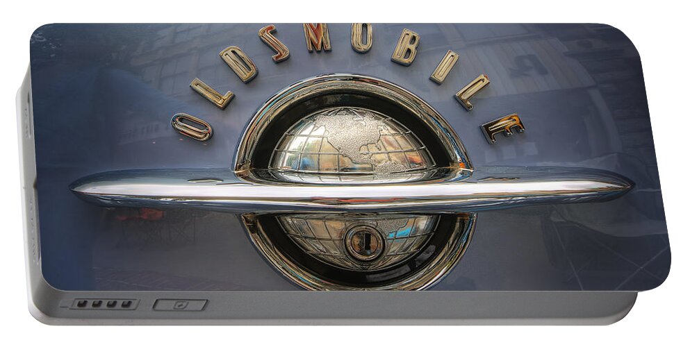 1952 Oldsmobile Logo Portable Battery Charger featuring the photograph 1952 Oldsmobile logo by Arttography LLC