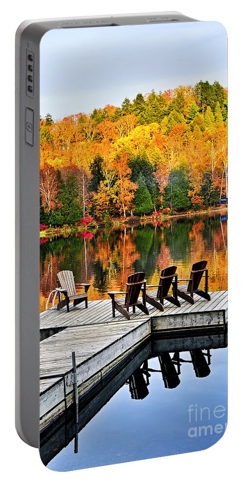 Lake Portable Battery Charger featuring the photograph Wooden dock on autumn lake by Elena Elisseeva