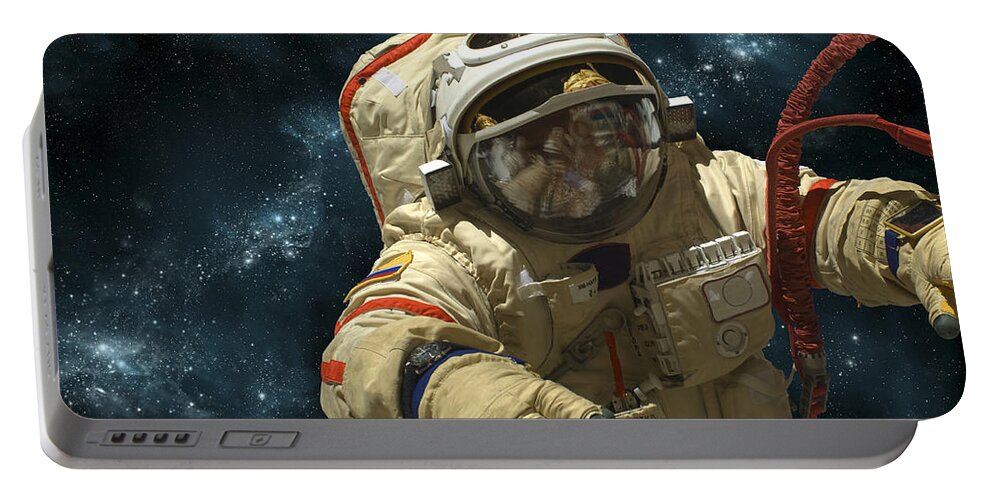 Astronaut Portable Battery Charger featuring the photograph A Cosmonaut Against A Background by Marc Ward