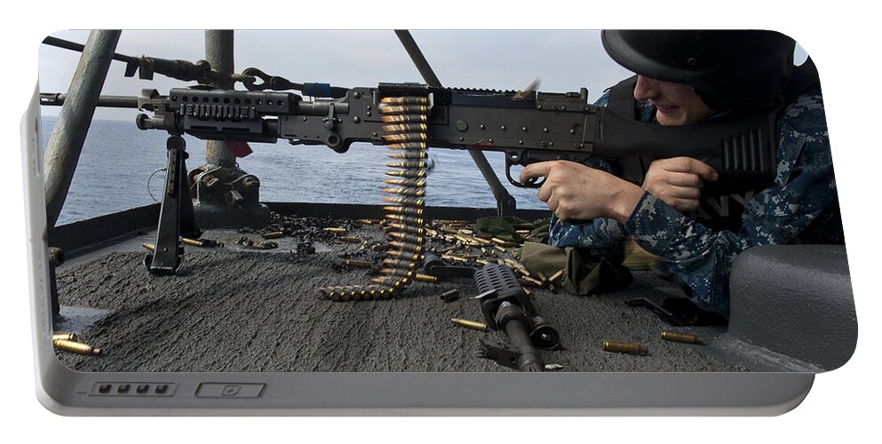 Military Portable Battery Charger featuring the photograph A Sailor Fires An M-240b Machine Gun by Stocktrek Images