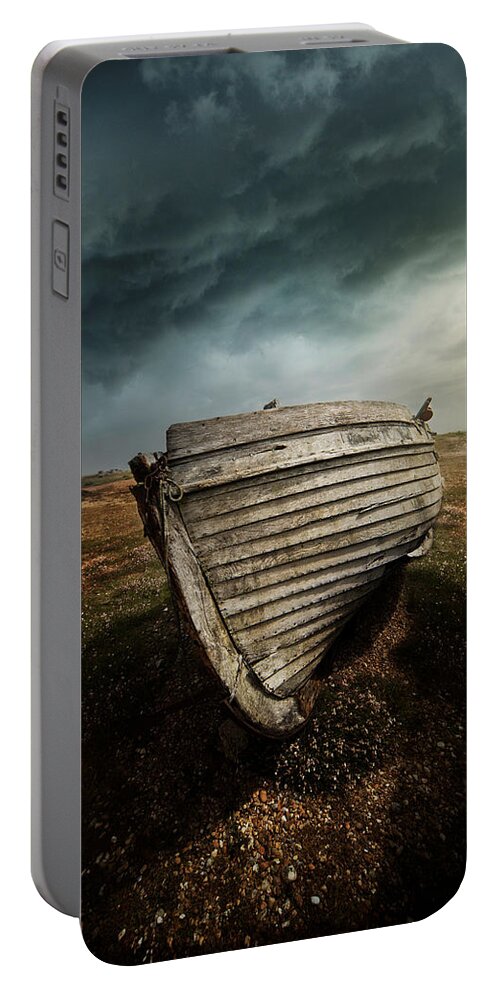 Boat Portable Battery Charger featuring the photograph An old wreck on the field. Dramatic sky in the background by Jaroslaw Blaminsky