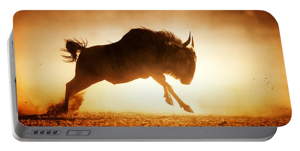 Wildebeest Portable Battery Charger featuring the photograph Blue wildebeest running in dust by Johan Swanepoel