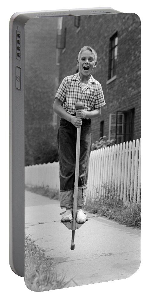 Boy Pogo Stick, C.1960s Portable Battery Charger by Debrocke/ClassicStock