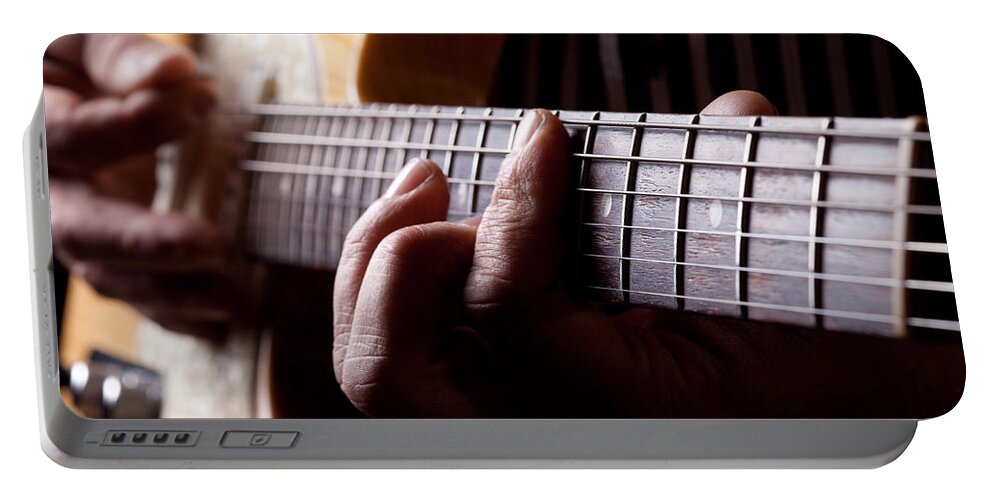 Age Portable Battery Charger featuring the photograph Close up shot of a man playing guitar by Kyle Lee