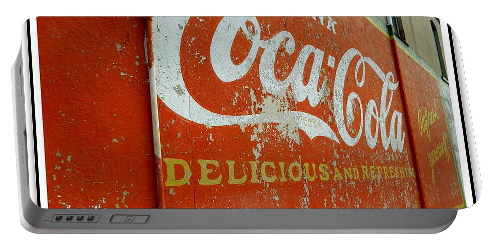 Coca-cola Portable Battery Charger featuring the photograph Coca-Cola on the Army Store Wall by Kathy Barney