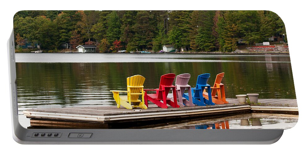 Five Portable Battery Charger featuring the photograph Colorful chairs at the lake by Les Palenik