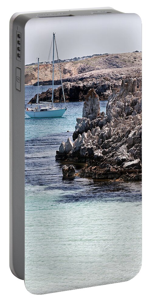 Bay Portable Battery Charger featuring the photograph In Cala Pudent Menorca the Cutting rocks in contrast with turquoise sea show us an awsome place by Pedro Cardona Llambias
