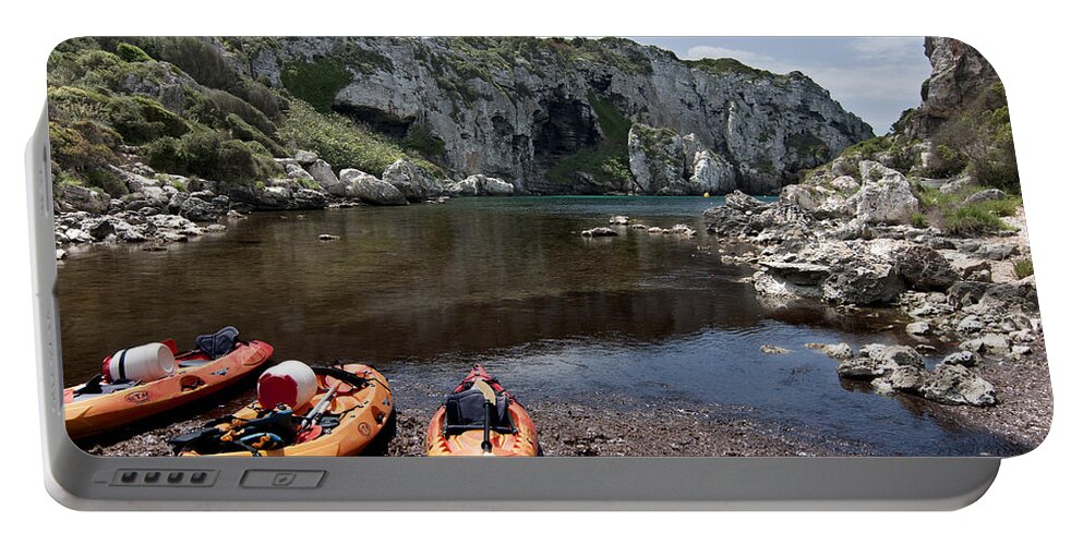 Blue Portable Battery Charger featuring the photograph Kayak time - The Landscape of Cales Coves Menorca is a great place for peace and sport by Pedro Cardona Llambias