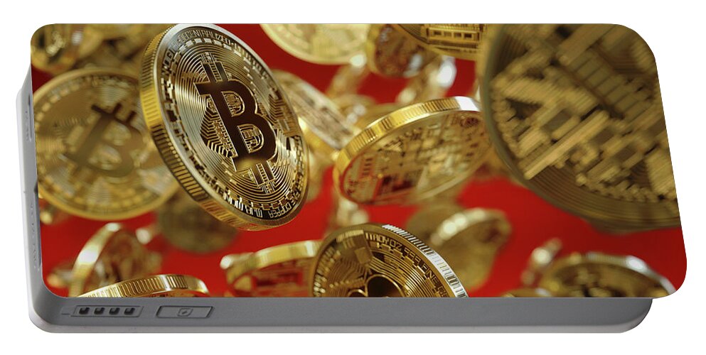 Abundance Portable Battery Charger featuring the photograph Lots Of Shiny New Gold Bitcoins Falling by Ikon Ikon Images