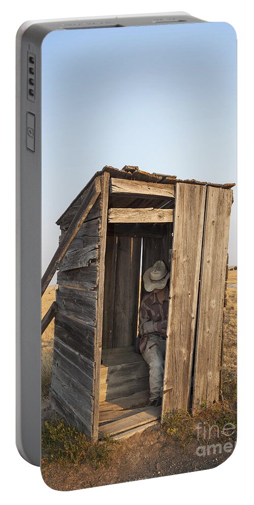 Mannequin Portable Battery Charger featuring the photograph Mannequin sitting in old wooden outhouse by Bryan Mullennix