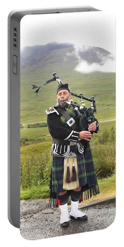 Bagpipe Portable Battery Charger featuring the photograph Playing bagpiper in Highlands by Patricia Hofmeester