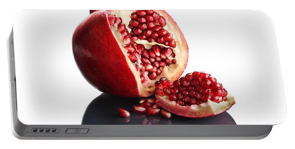 Pomegranate Portable Battery Charger featuring the photograph Pomegranate opened up on reflective surface by Johan Swanepoel