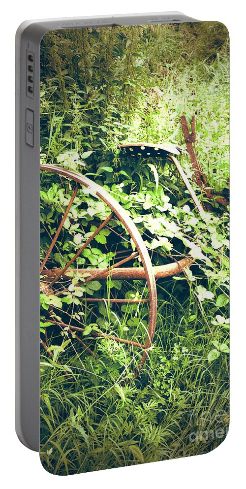 Farm Portable Battery Charger featuring the photograph Rusty antique machinery by Perry Van Munster