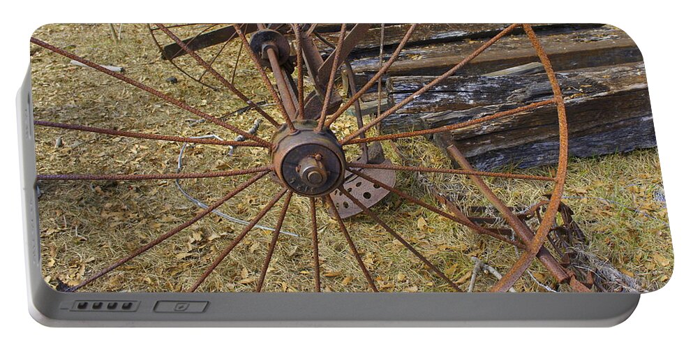 Field Portable Battery Charger featuring the photograph Rusty Wheel by Laurie Perry