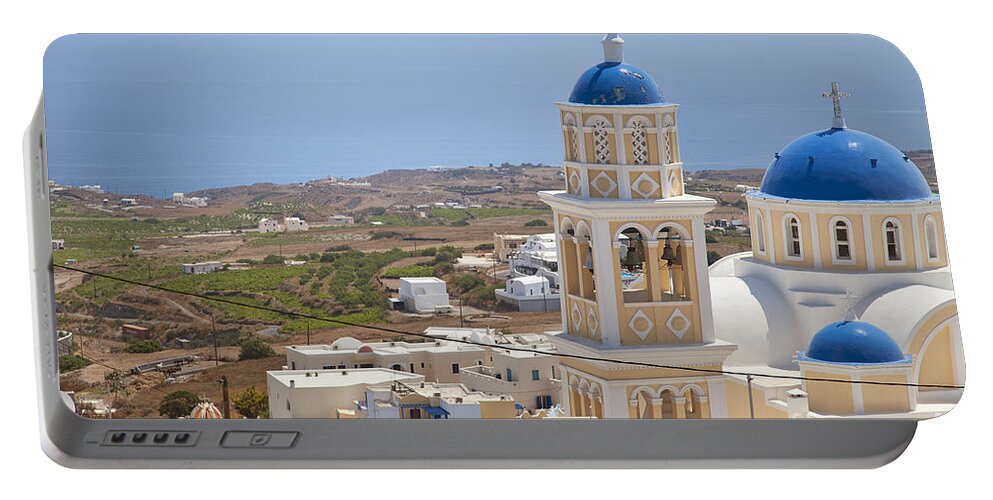 Fira Portable Battery Charger featuring the photograph Santorini church overlooking the sea by Sophie McAulay