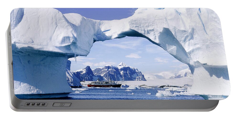 Antarctic Portable Battery Charger featuring the photograph Ship Through Arch Of Iceberg by George Holton
