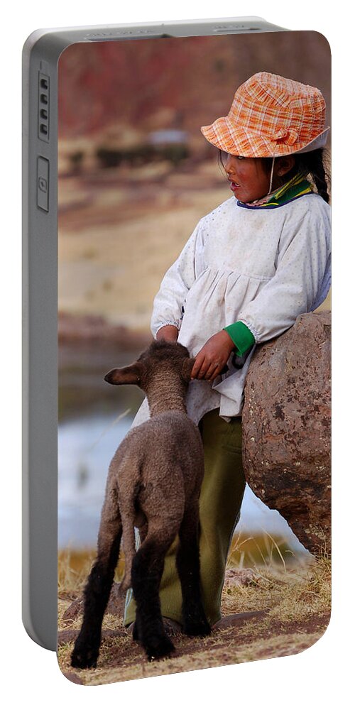 Girl Portable Battery Charger featuring the photograph Sillustani Girl with hat and lamb by RicardMN Photography