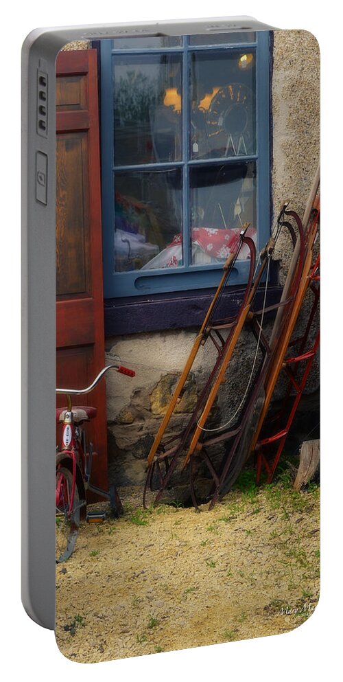 The Old Sleds Portable Battery Charger featuring the photograph The Old Sleds by Mary Machare
