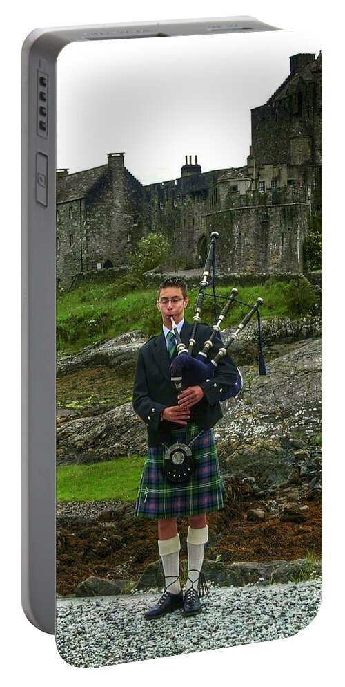 Eileen Dolan Castle Portable Battery Charger featuring the photograph The Piper at Eilean Donan Castle by Joan-Violet Stretch