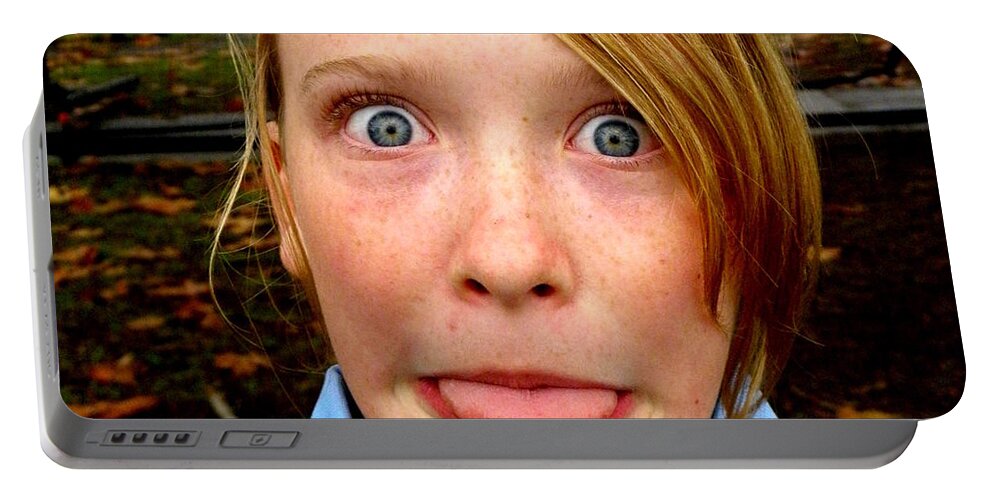 Funny Face Tongue Eyes Girl Shock Portable Battery Charger featuring the photograph The wind will change by Guy Pettingell
