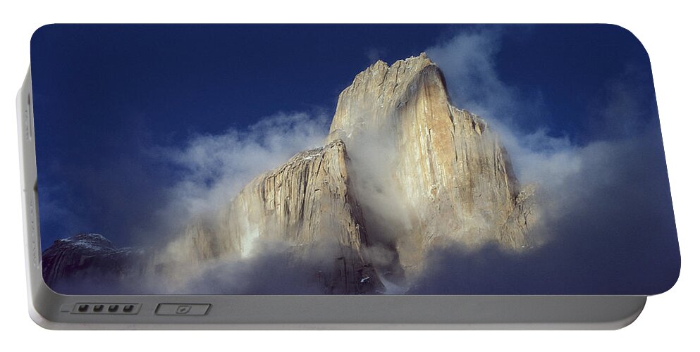 Feb0514 Portable Battery Charger featuring the photograph Trango Tower In Morning Mist Karakoran by Geoff Gabites