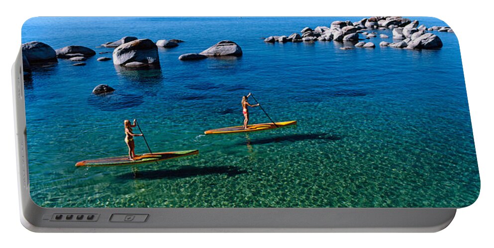 Photography Portable Battery Charger featuring the photograph Two Women Paddle Boarding In A Lake by Panoramic Images
