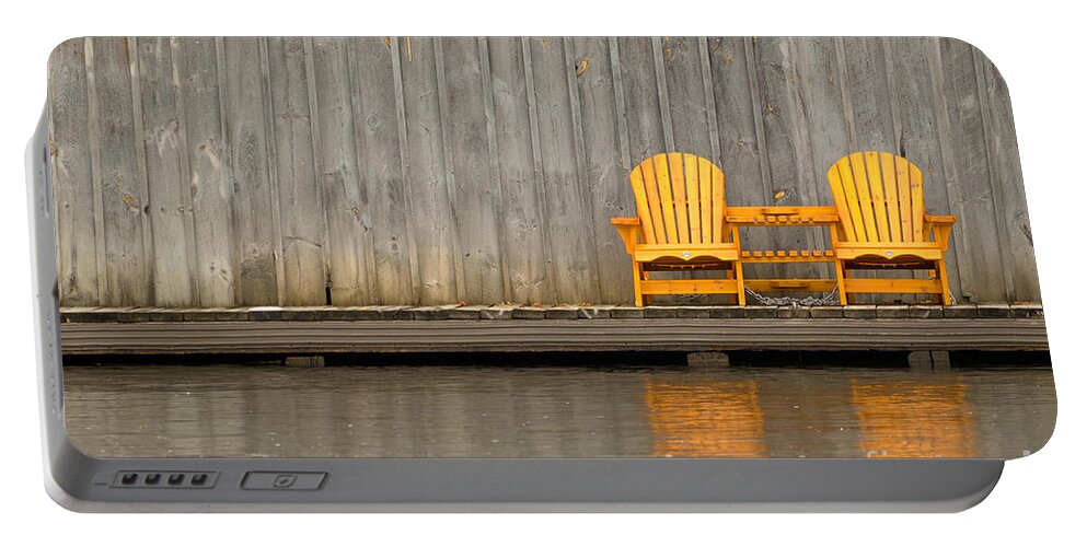 Two Portable Battery Charger featuring the photograph Two wooden chairs on an old dock by Les Palenik