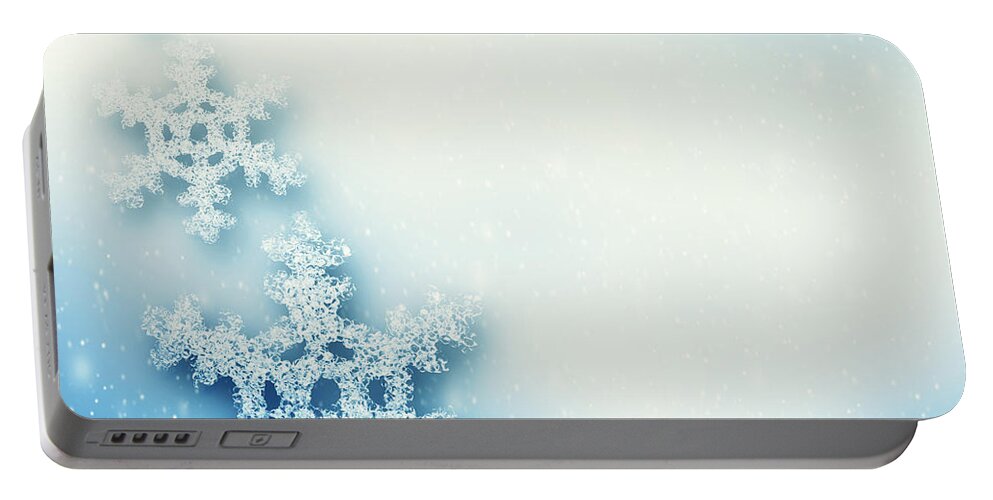 Snowflake Portable Battery Charger featuring the photograph Winter Christmas background with big snowflakes by Michal Bednarek
