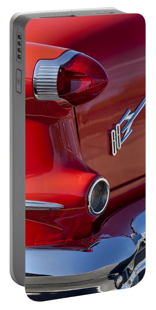 1956 Oldsmobile 88 Portable Battery Charger featuring the photograph 1956 Oldsmobile 88 Taillight Emblem by Jill Reger