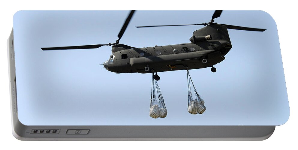 National Guard Portable Battery Charger featuring the photograph A Ch-47 Chinook Carrying Sandbags by Stocktrek Images