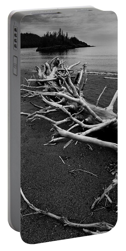 Black And White Portable Battery Charger featuring the photograph Dead barren tree trunk on Driftwood Beach near WaWa Ontario by Randall Nyhof