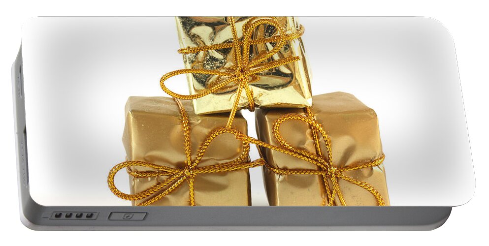 Anniversary Portable Battery Charger featuring the photograph Gold wrapped parcels by Simon Bratt