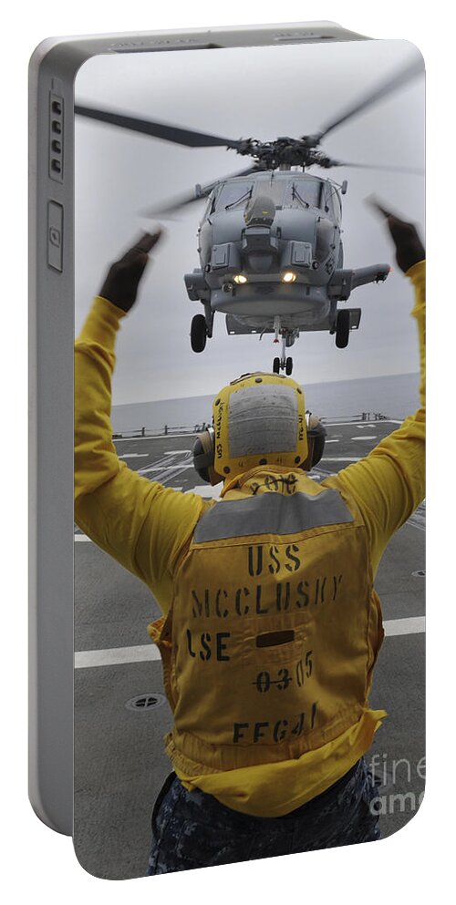Guided Missile Frigate Portable Battery Charger featuring the photograph Petty Officer Guides An Sh-60r Sea Hawk by Stocktrek Images