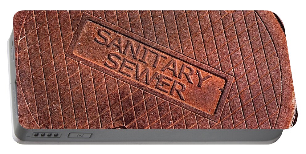 Sign Photographs Portable Battery Charger featuring the photograph Sewer Cover by Bill Owen