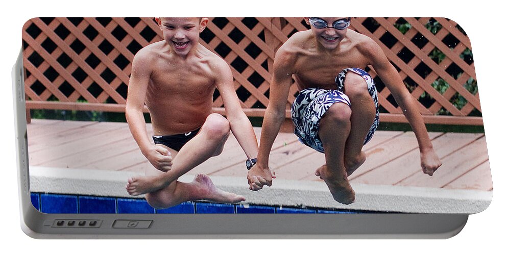 Synchronized Portable Battery Charger featuring the photograph Synchronized Cannonballs by Farol Tomson