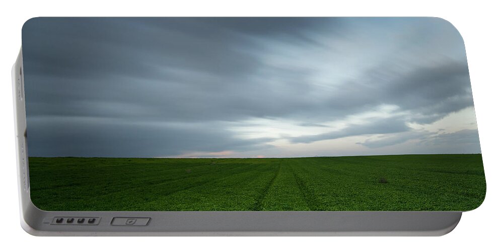 Green Field Portable Battery Charger featuring the photograph Green field and cloudy sky by Michalakis Ppalis