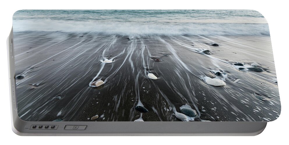 Seascape Portable Battery Charger featuring the photograph Pebbles in the beach and flowing sea water by Michalakis Ppalis
