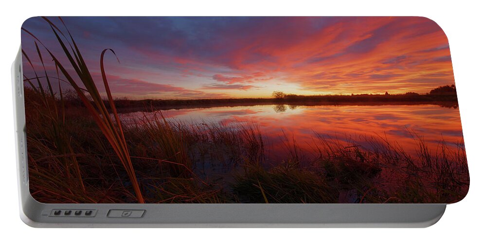 Sunset Portable Battery Charger featuring the photograph A Prairie Pothole by Dan Jurak