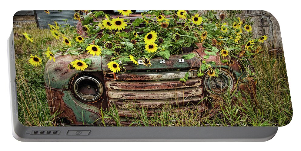 Art Portable Battery Charger featuring the photograph Abandoned Old Ford Truck with Yellow Flowers in the Ghost Town by Okaton South Dakota by Randall Nyhof