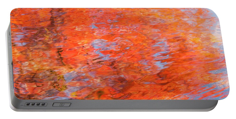 Autumn Portable Battery Charger featuring the photograph Colors reflecting in a pond becomes a wash of color. by Usha Peddamatham
