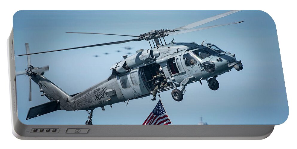 Military Portable Battery Charger featuring the painting An MH-60S Sea Hawk helicopter displays the American flag. by Celestial Images